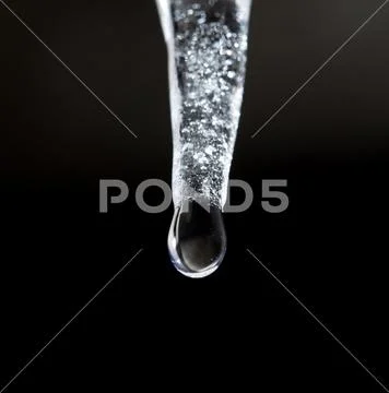Icicle on a black background Stock Photos