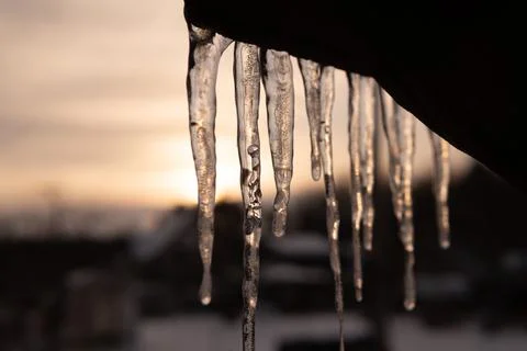 Icicle with bubble in it and sun behind. Beautiful icicle. Stock Photos