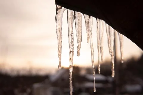 Icicle with bubble in it and sun behind. Beautiful icicle. Stock Photos