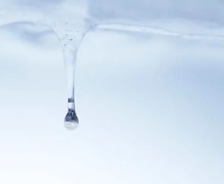 Icicle with drop of water Stock Photos