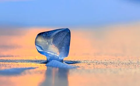 Icicle on the ice at sunset Stock Photos