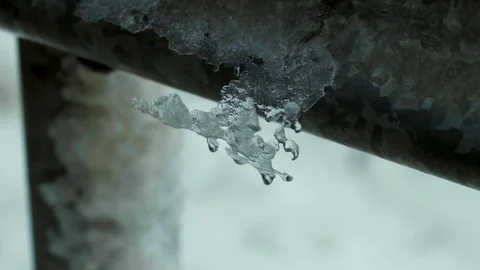 Icicle on road barrier breaks falls off slomo Stock Footage 84785002