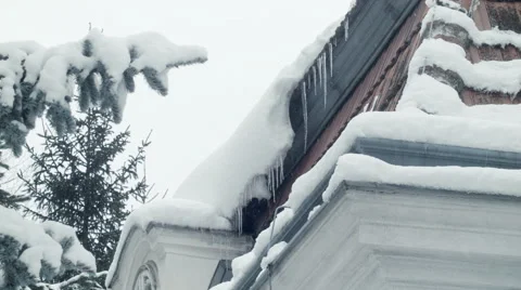 Icicles 001 on rooftop with trees, snow and falling snow in vienna Stock Footage 45701668