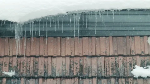 Icicles 002 on rooftop with snow and falling snow in vienna Stock Footage 45701679