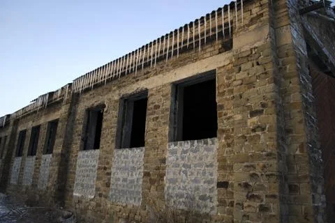 Icicles on abandoned building Stock Photos
