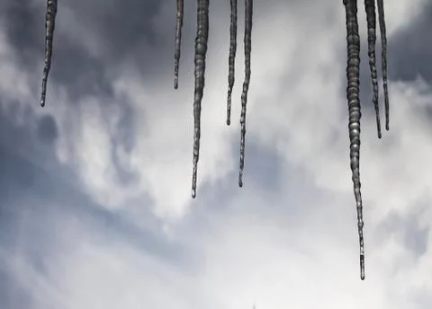 Icicles and clouds Stock Photos
