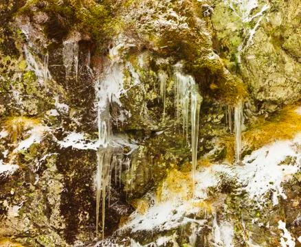 Icicles and rocks Stock Photos