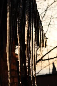 Icicles and sunlight reflected on it Stock Photos