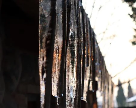 Icicles and sunlight reflected on it Stock Photos