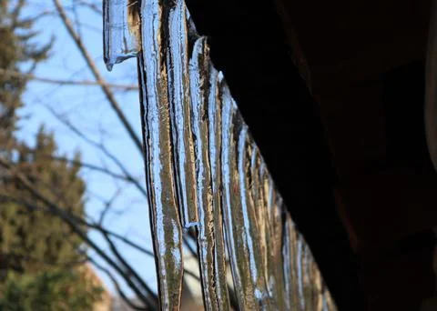 Icicles and sunlight reflected on it Stock Photos