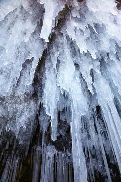 Icicles background on the ice wall on Baikal lake at winter Stock Illustration