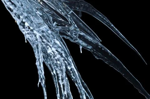 Icicles on a black background Stock Photos