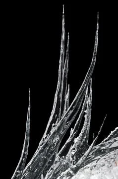 Icicles on a black background Stock Photos