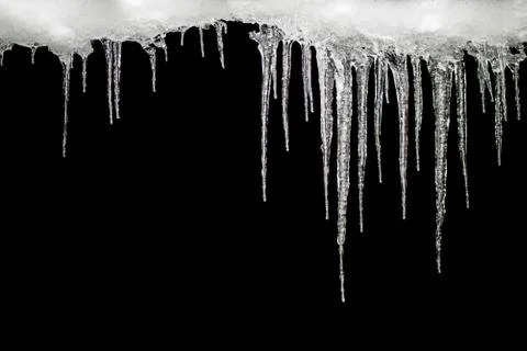 Icicles on a black background, space for text, template for design Stock Photos