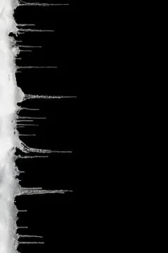 Icicles on a black background, space for text, template for design Fotos Stock