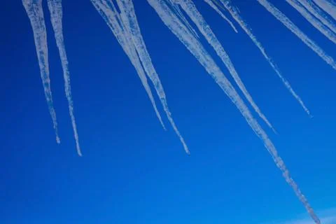 Icicles on a blue background. Stock Photos