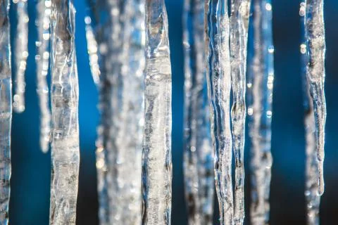 Icicles on a bright spring sun close, blurred abstract background Stock Photos