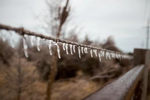 Icicles dangling from a strand of wire or rope Stock Photos