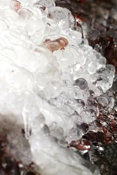 Icicles on dark background Stock Photos