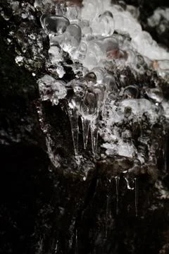Icicles on dark background Stock Photos