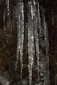 Icicles on dark background Stock Photos