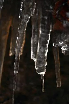 Icicles on dark background Stock Photos