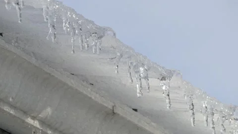Icicles dripping off home gutter Stock Footage 145849450
