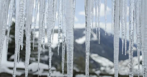 Icicles dripping in winter, melting ice due to high temperature. Stock Footage 127186367