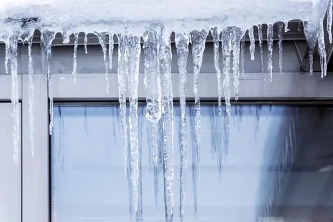 Icicles on the eaves. Stock Photos