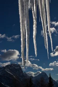 Icicles formations with mountains in the background. Stock Photos