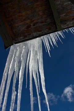 Icicles formations with mountains in the background. Stock Photos