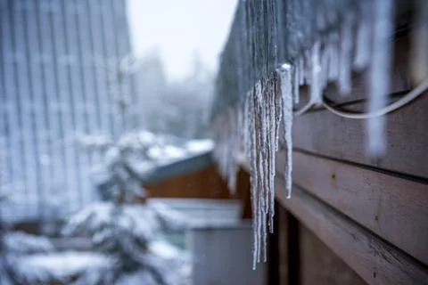 Icicles in front of the house. Stock Photos