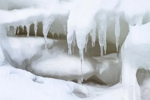 Icicles grow on an ice wall Stock Photos