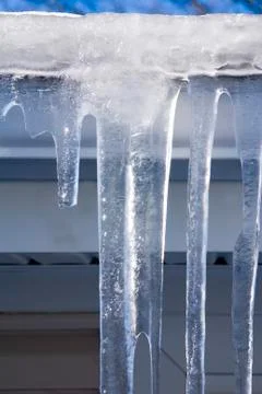 Icicles on the gutter closeup Stock Photos