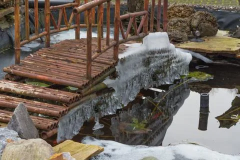 Icicles hanging from a bridge Stock Photos