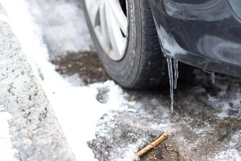 Icicles hanging from a car Stock Photos