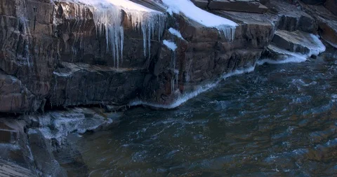 Icicles Hanging Down Over a Winter River Stock Footage 100688586