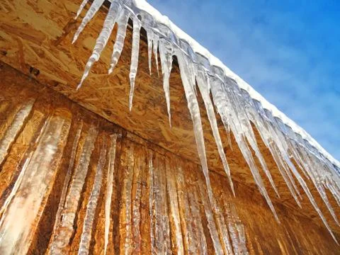 Icicles hanging from the edge Stock Photos