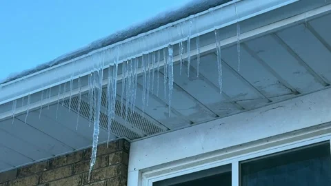 Icicles Hanging off Gutter in Front of Bay Window - House Stock Footage 322837889