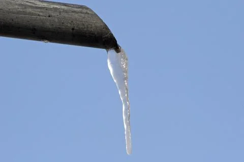 Icicles hanging from the pipe Stock Photos