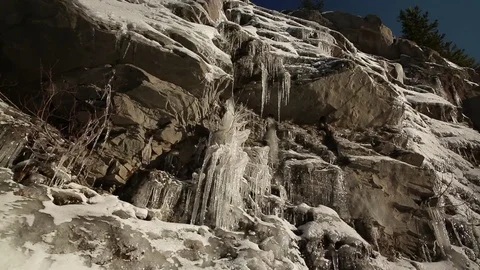 Icicles hanging from rock during winter Stock Footage 83866762
