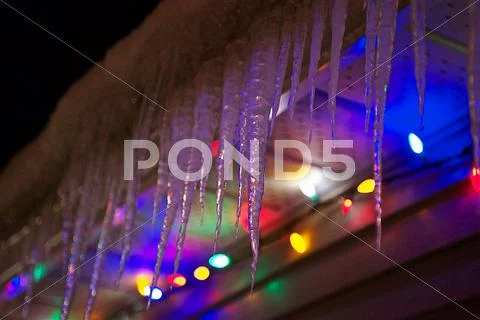 Icicles hanging from roof Stock Photos