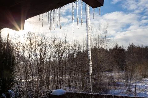 Icicles hanging from a roof in a winter landscape. 스톡 사진