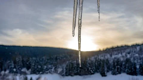 Icicles hanging from the window Stock Photos