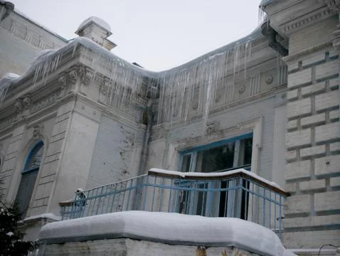 Icicles of ice on the old building Stock Photos