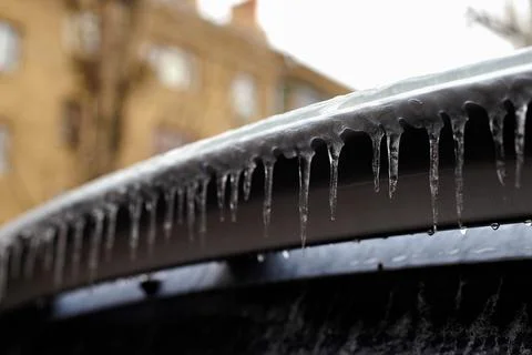 Icicles on the machine. Icicles on the trunk of a car Stock Photos