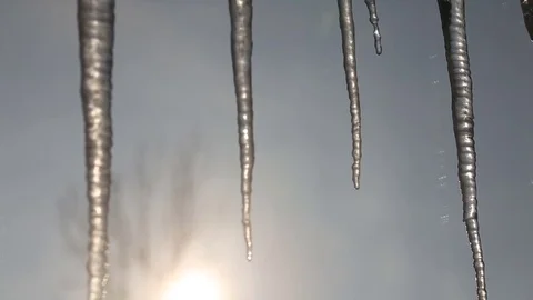 Icicles melt through the window as the sun rises in the background Video stock 72198432