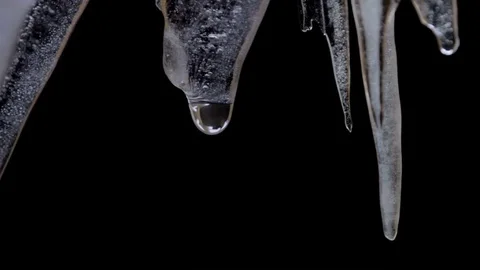 Icicles melts and drips on a black background Stock Footage 85323977