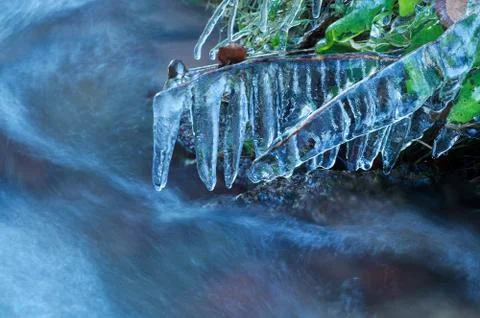 Icicles by mountain river in winter Stock Photos