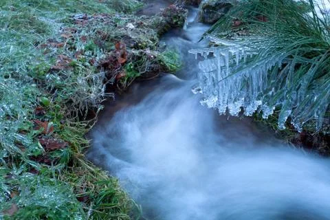 Icicles on mountain river in winter Stock Photos